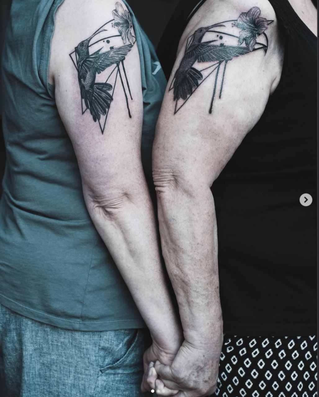 Matching hummingbird and flower shoulder tattoos