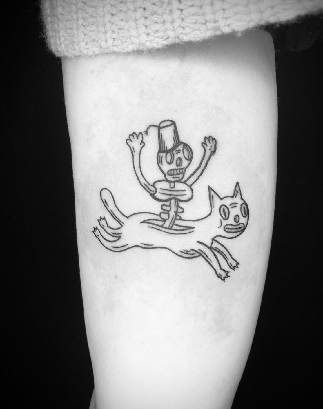 Playful skeleton riding a cat line tattoo