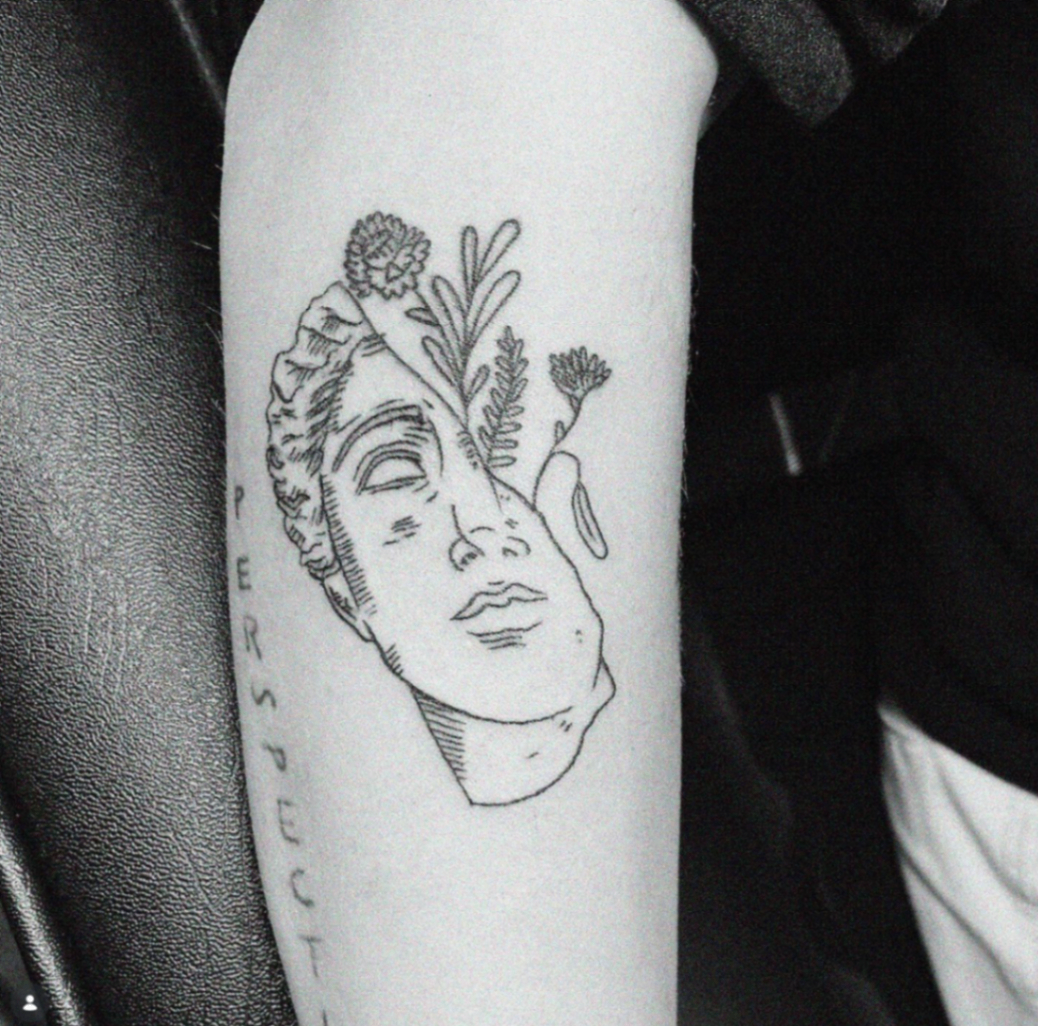 Minimal classical statue face with botanical accents