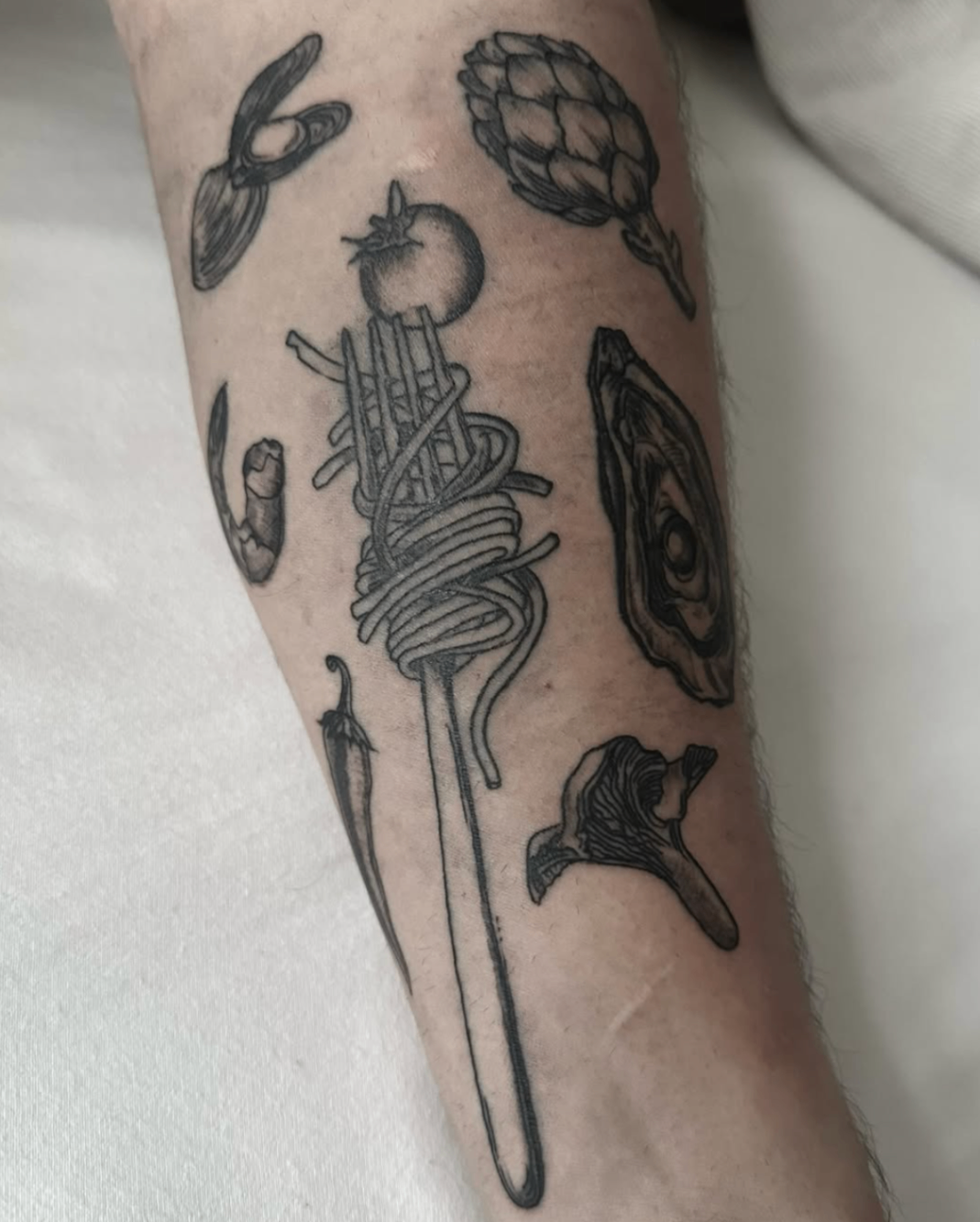 Blackwork pasta fork surrounded by italian ingredients